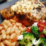 Baked Feta Chicken with Broccoli Red Pepper and Goat Cheese on a plate