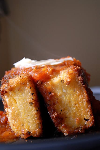 Fried Grit Cakes topped with marinara and parmesan