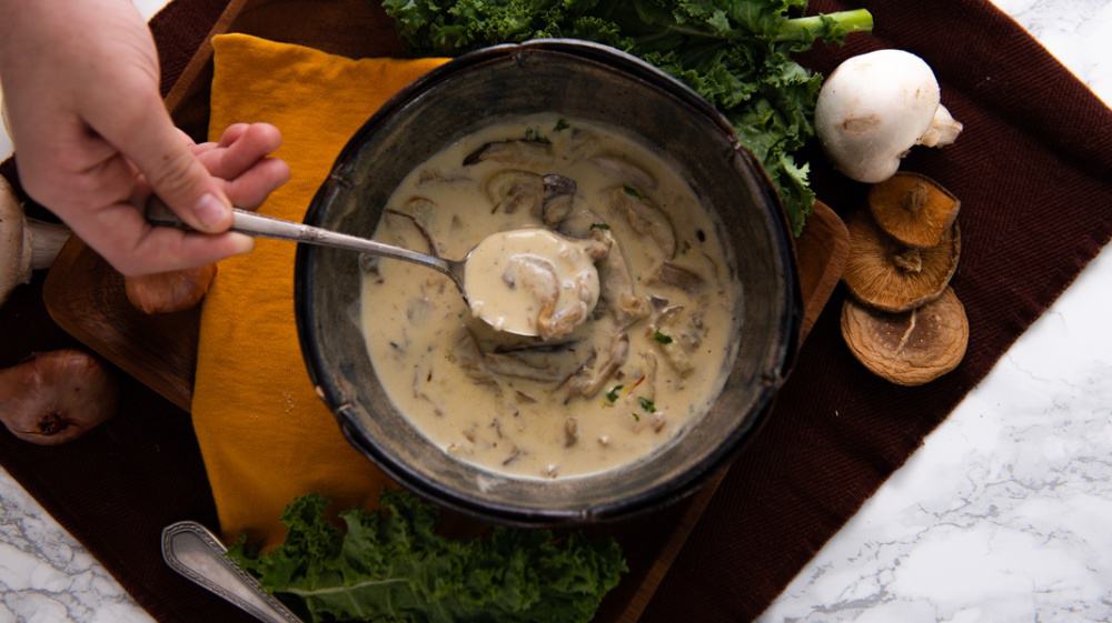 Creamy Wild Mushroom Soup with hand